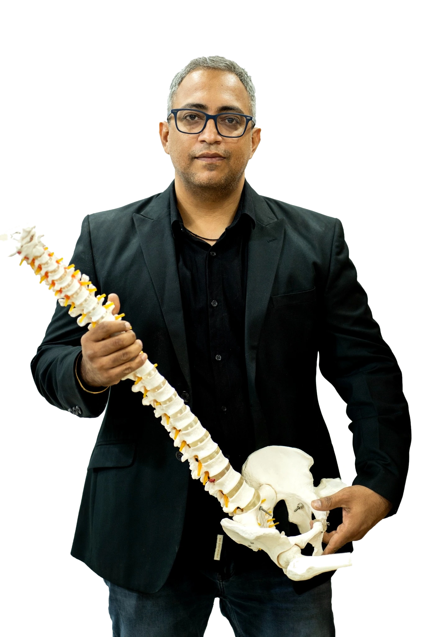 Dr Harish Tahiliani with spine model for chiropractic care in Jodhpur